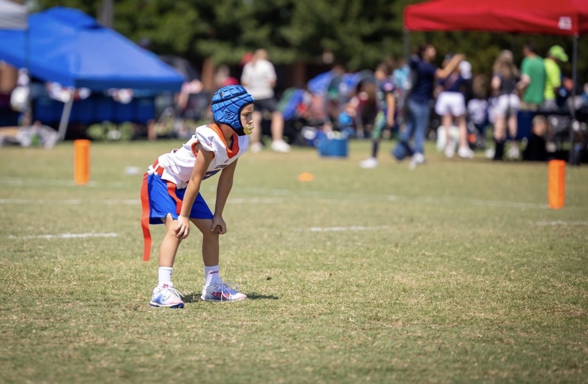 Flag football player in ready stance on the line