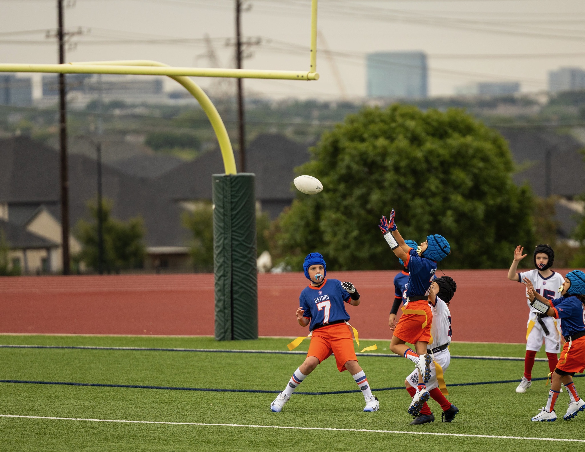 Youth flag football player leaping to catch a pass