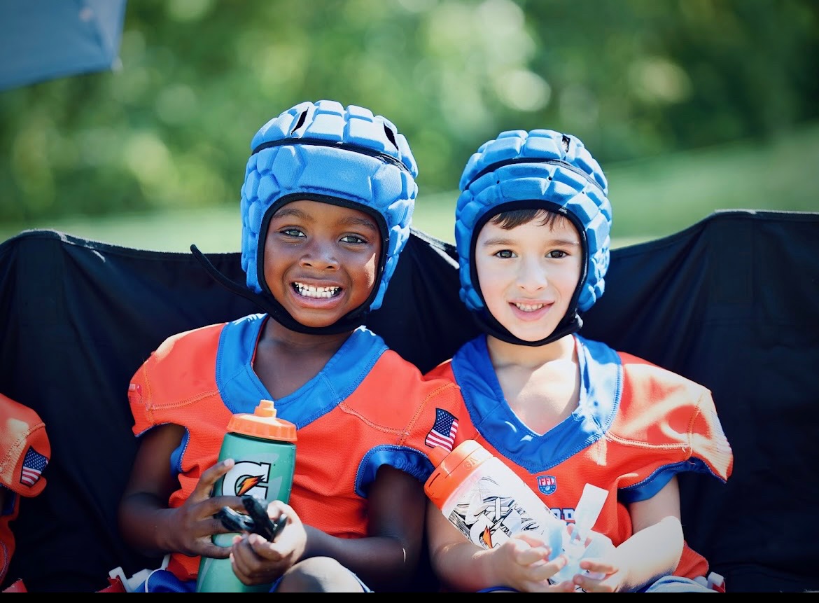 Two teammates smiling with their sports drinks