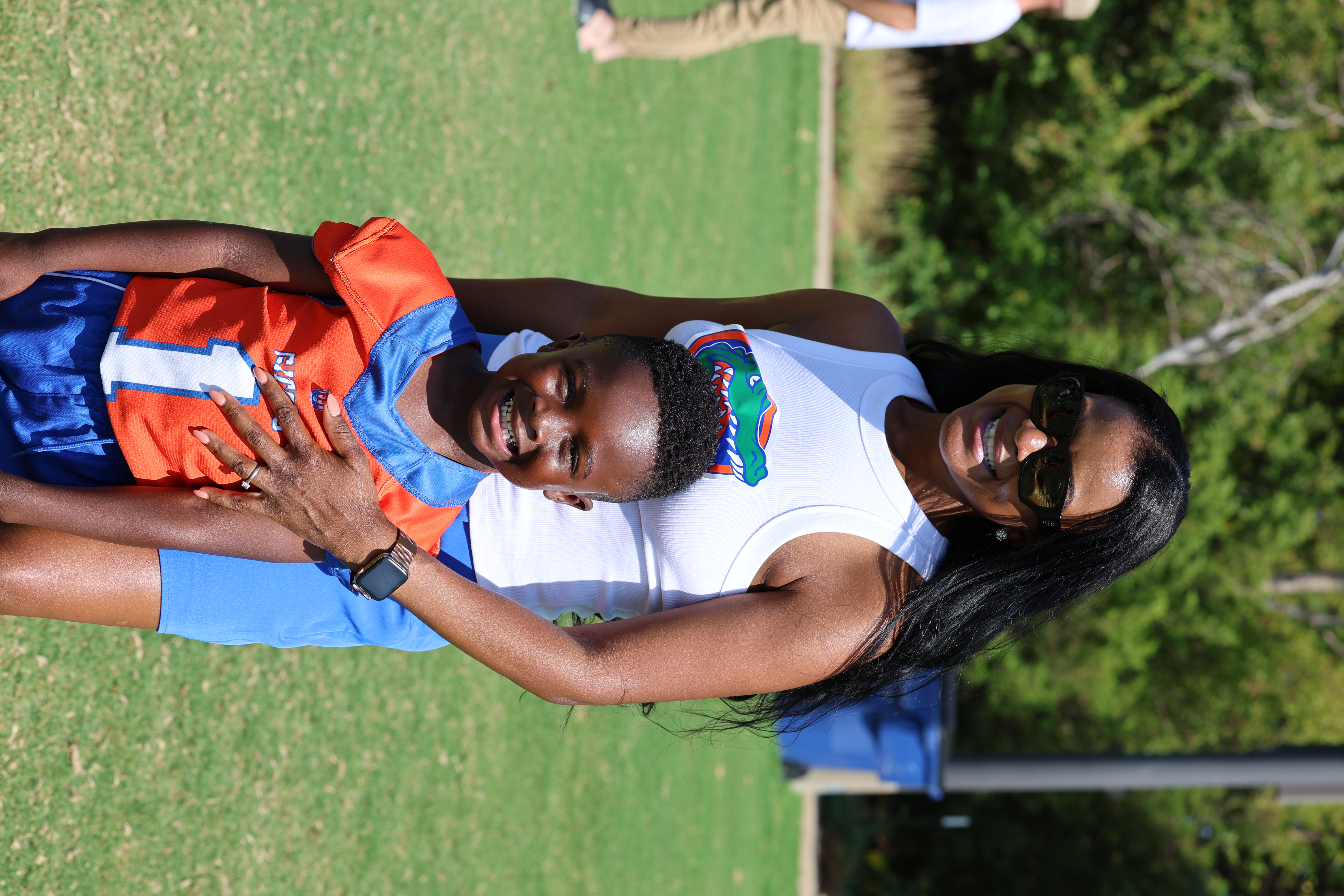 Mom celebrating with her son after a flag football game