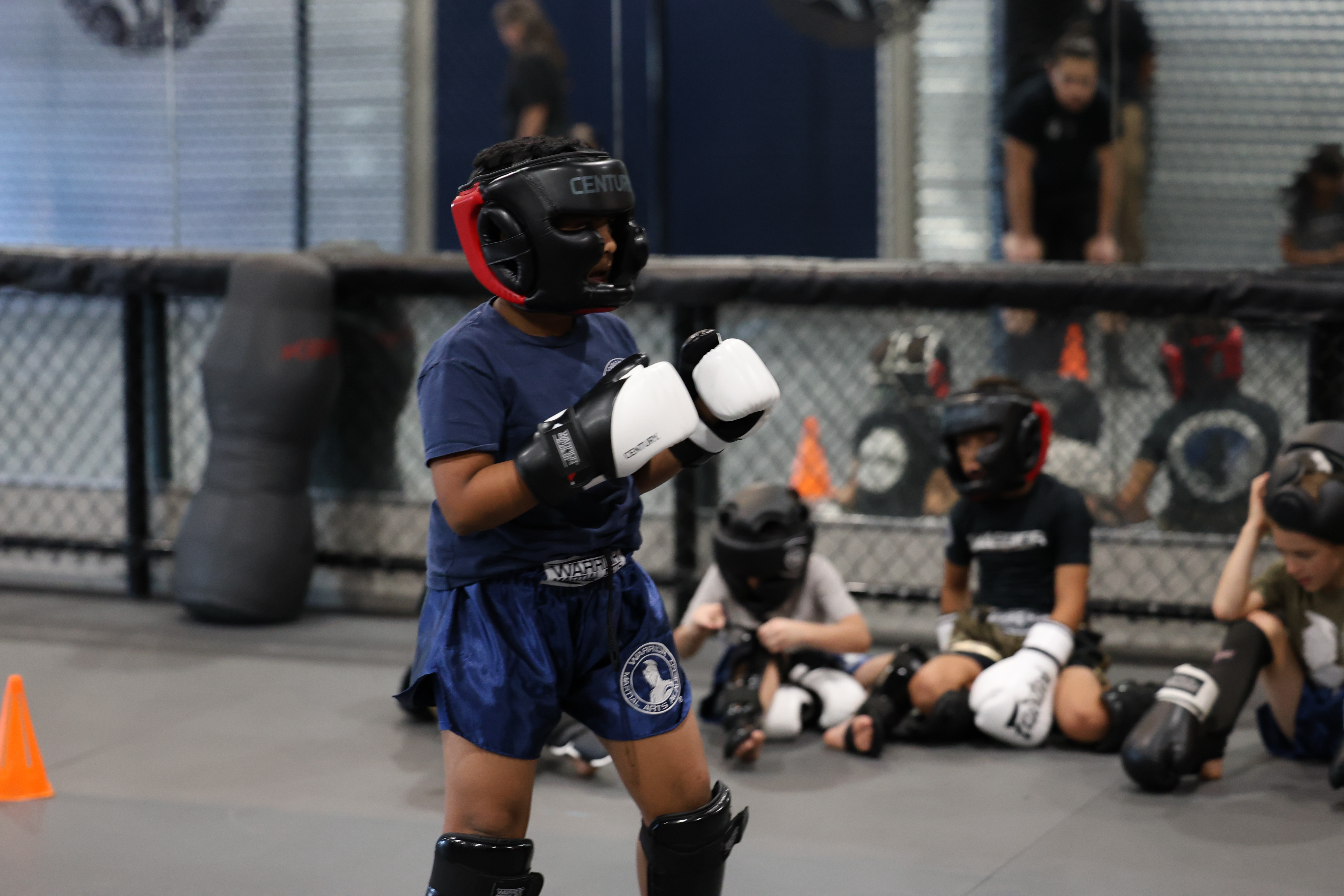 Young martial artist throwing a punch in sparring gear
